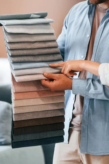 Interior consultant showing fabric samples for curtain selection