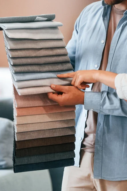 Interior consultant showing fabric samples for curtain selection